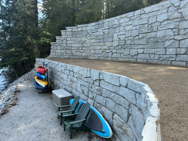 Two-tier stacked-stone wall with lakeside staging area