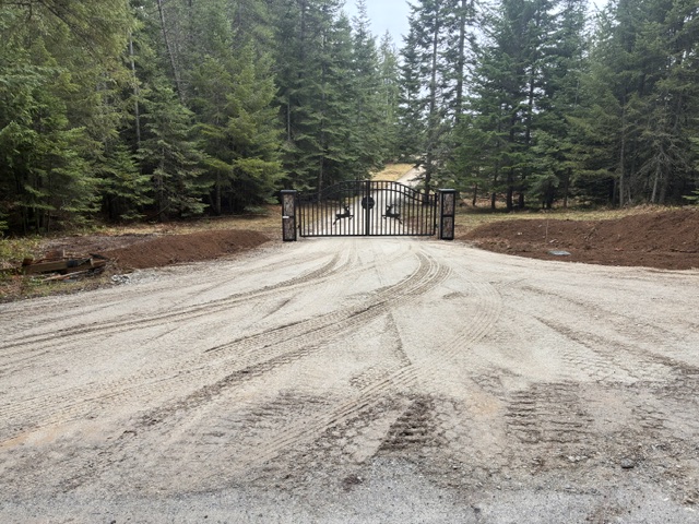 New gravel driveway with custom entry gate